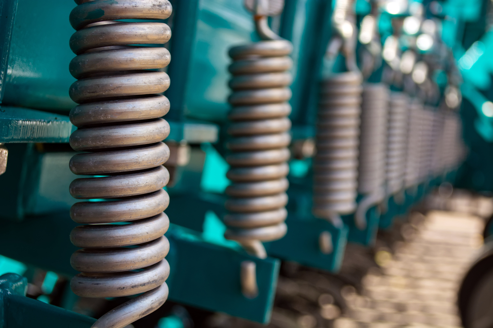 Metal,springs,standing,in,a,row,on,the,soil Processing,unit