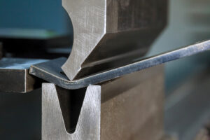 Bending,sheet,metal,with,a,hydraulic,machine,at,the,factory.