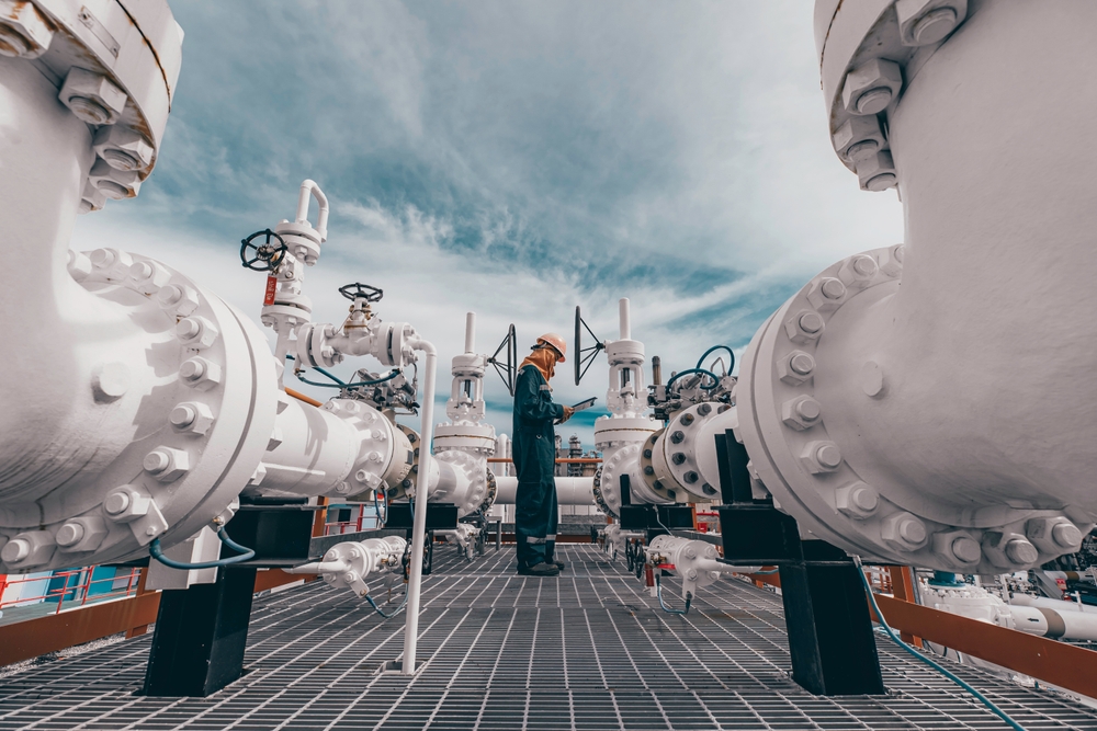 Male,worker,inspection,at,steel,long,pipes,and,pipe,elbow