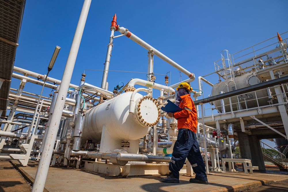 Male,worker,inspection,at,the,exchanger,of,tank,oil,refinery